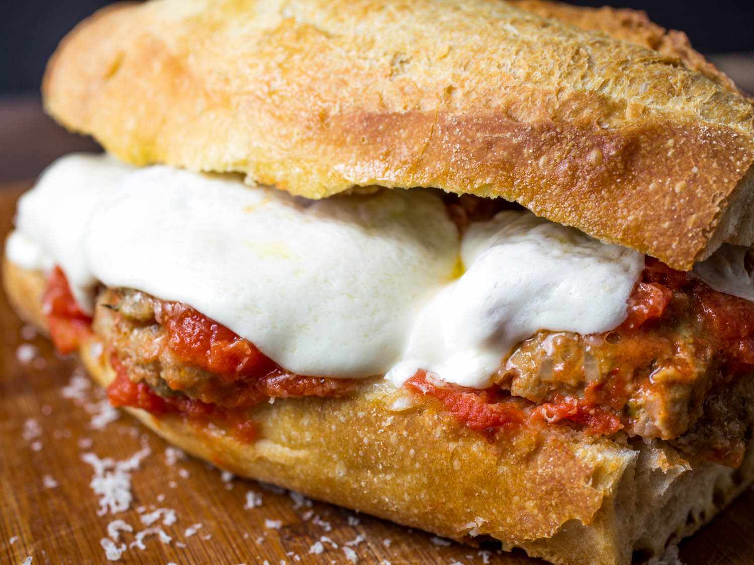 An Italian American meatball sandwich with melted mozzarella cheese and tomato sauce.