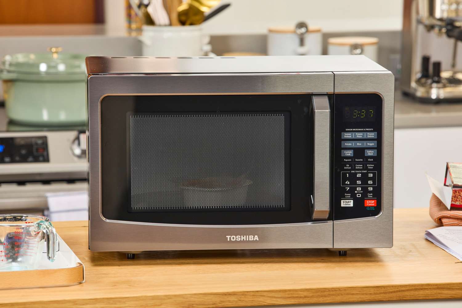 The Toshiba EM131A5C-BS Microwave Oven on a wooden counter