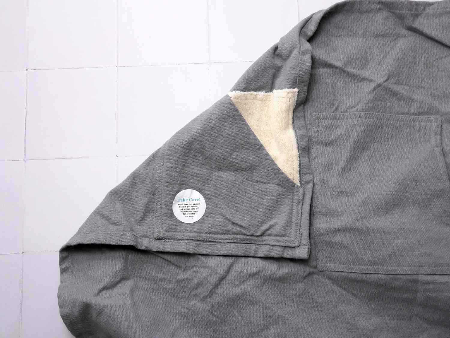 a closeup of the pot holders built into an apron