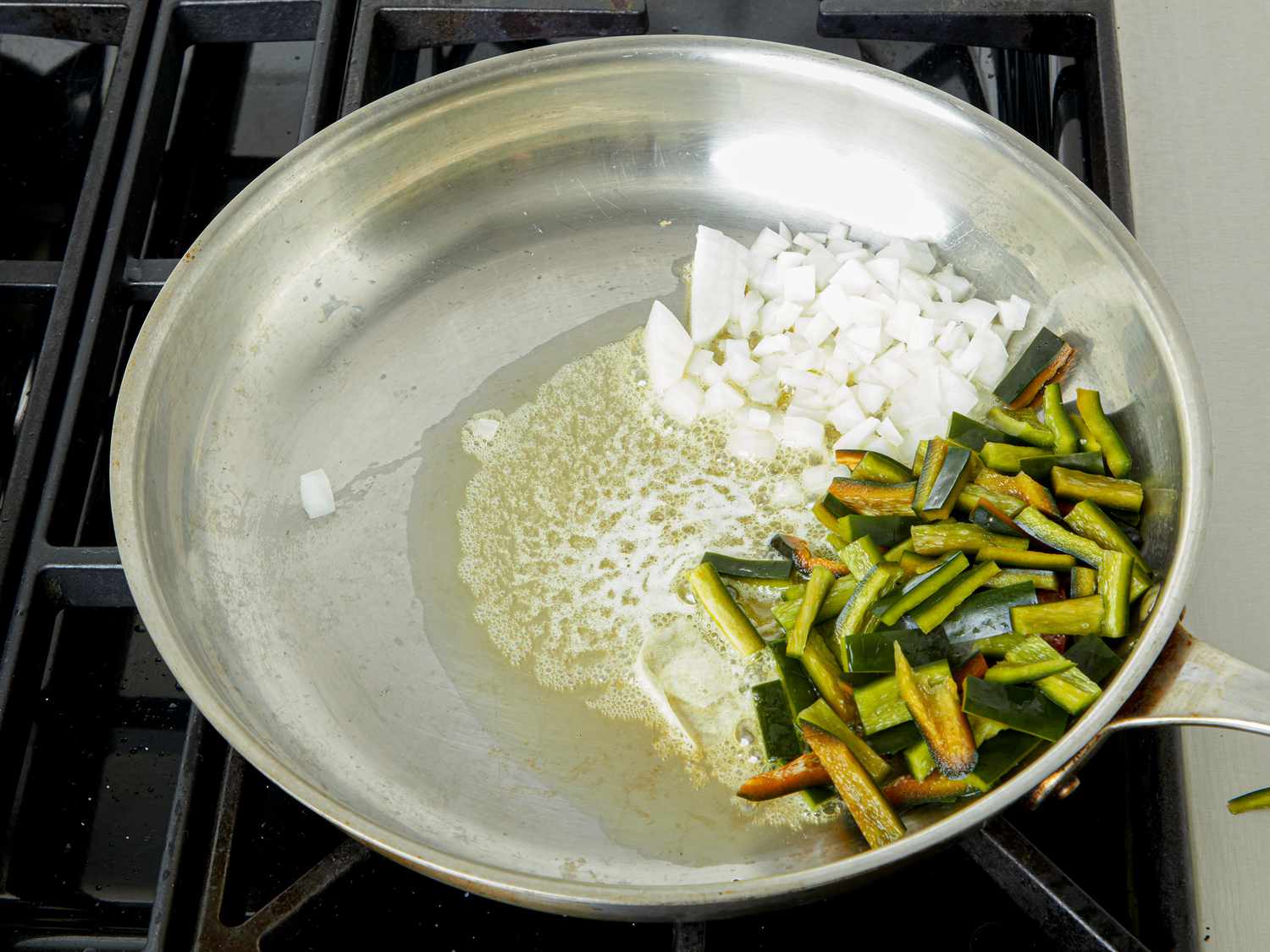 Overhead view of vegetables cooking in pan