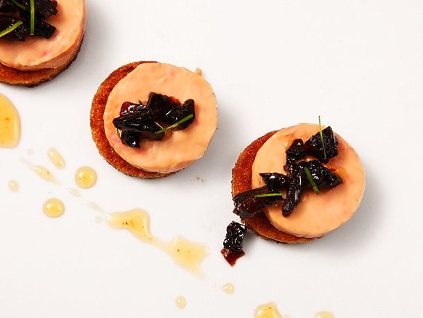 Foie gras torchon canapés made with fried toast and sweet, cognac-soaked prunes.