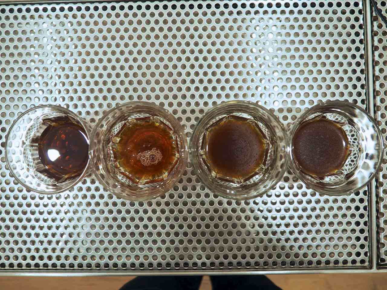 Iced coffee prepared in four different ways, all served in small glasses.