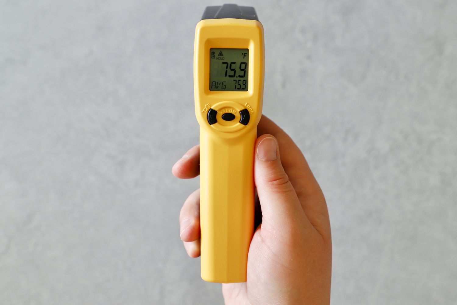 The ThermoWorks infrared thermometer in someone's hand.