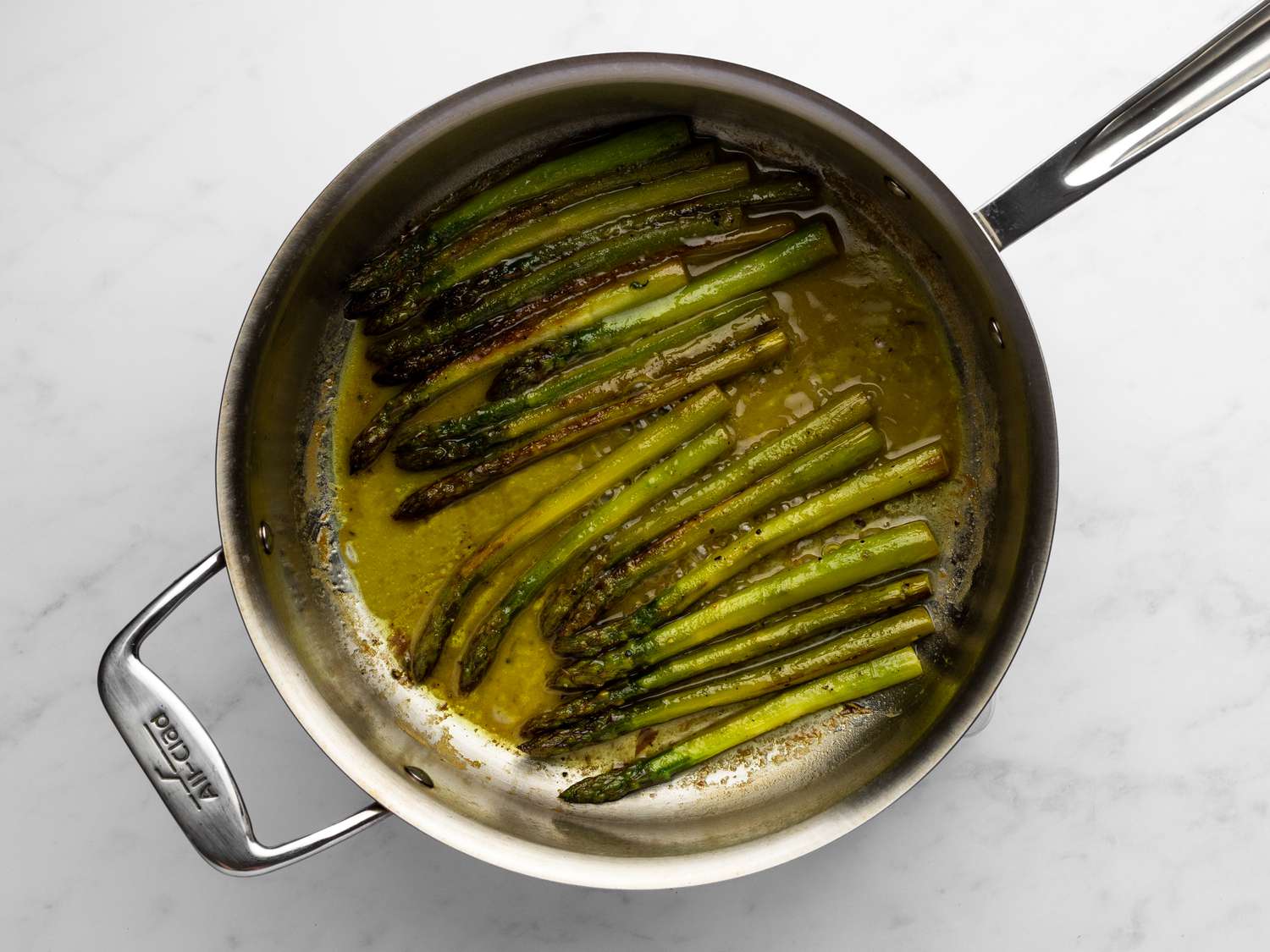 Tender asparagus inside sautÃ© pan