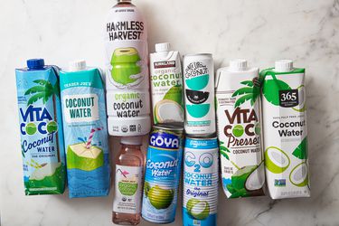 A variety of coconut water brands in cartons and bottles displayed on a surface