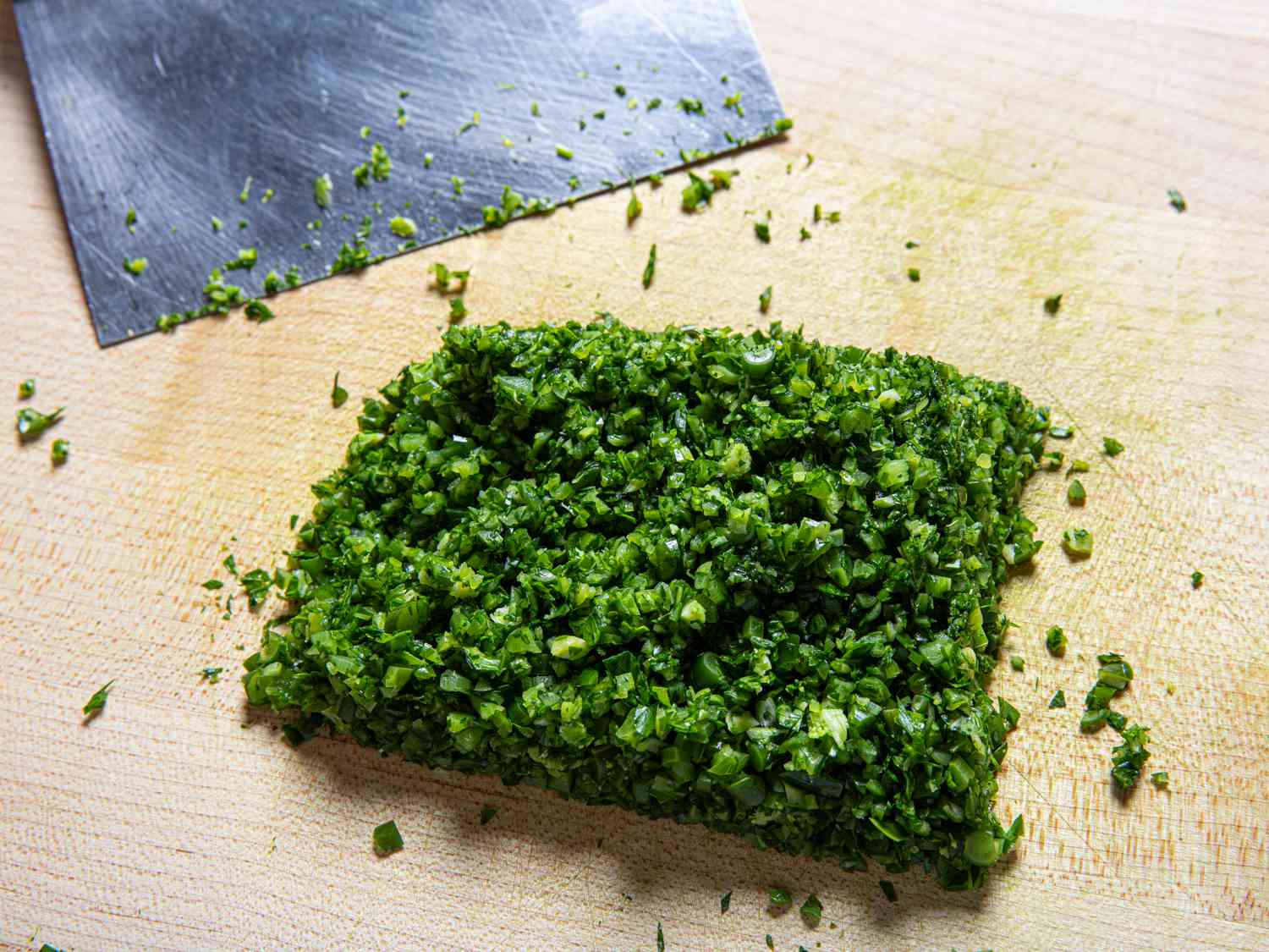Minced garlic scapes on a cutting board