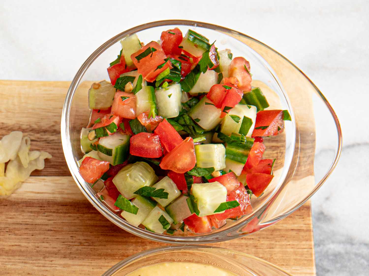 Overhead view of tomatoes and cucumbers in a small bowl
