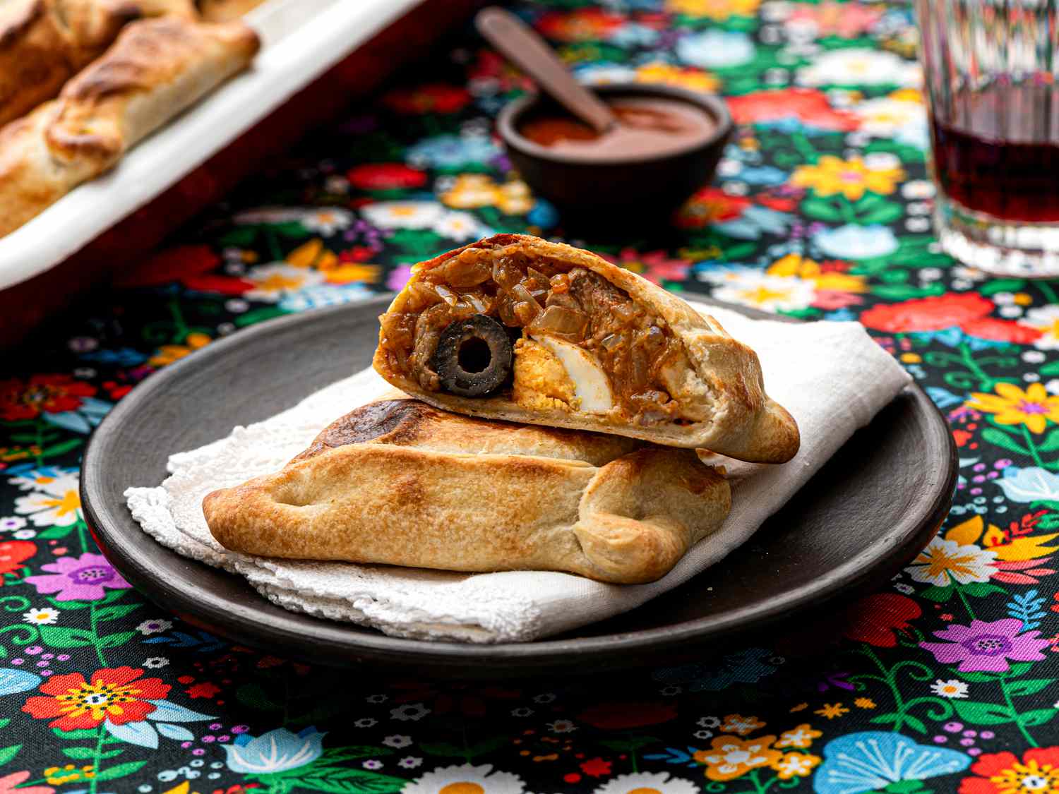 Side view of Empanadas de Pino on a traditional Chilean fabric