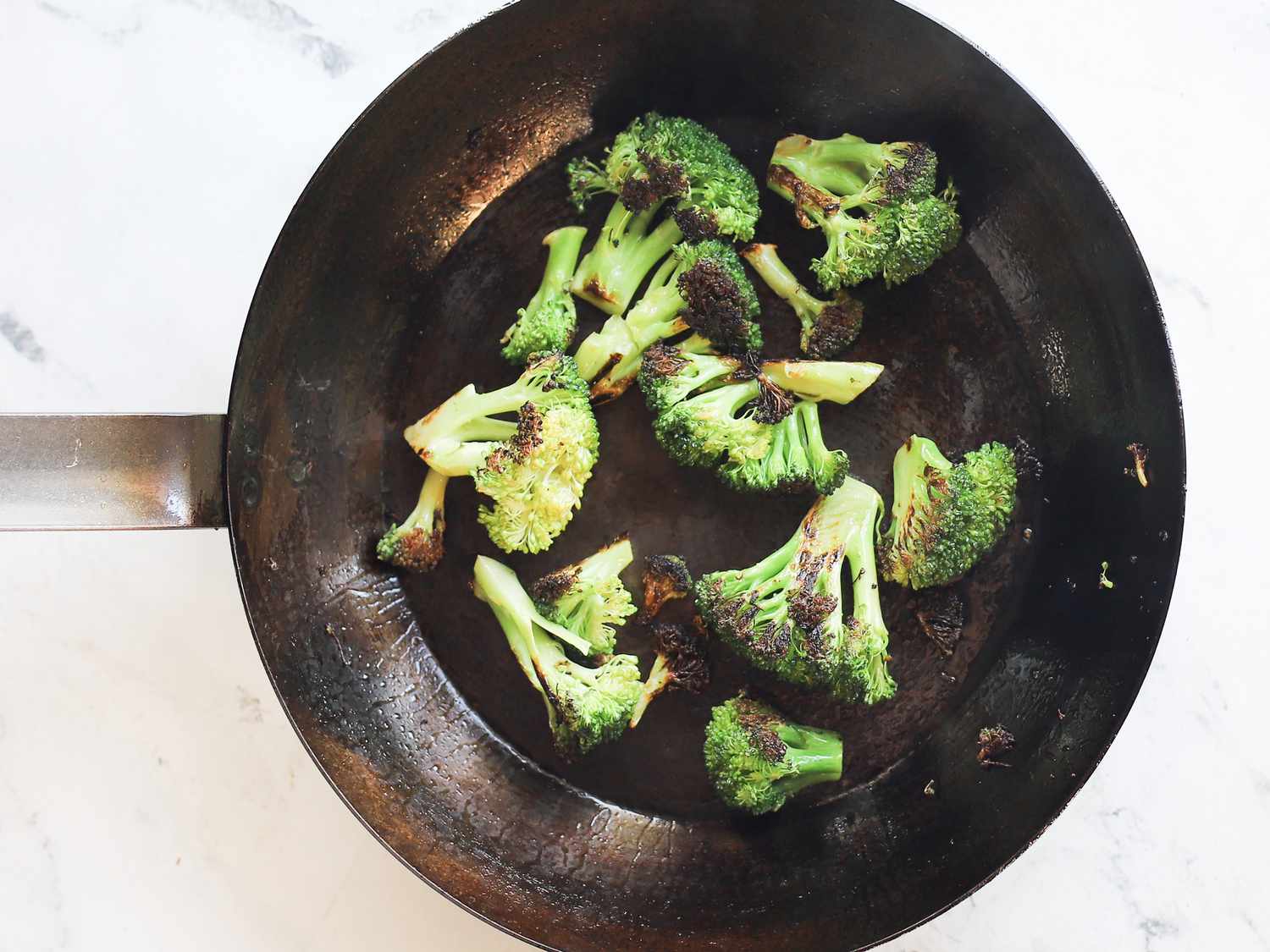 vollrath carbon steel skillet with broccoli charred inside