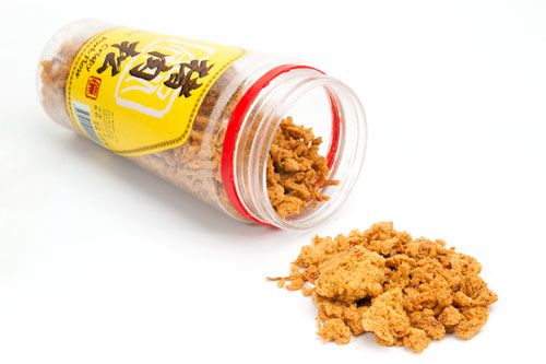A spilled over container of crispy pork floss.