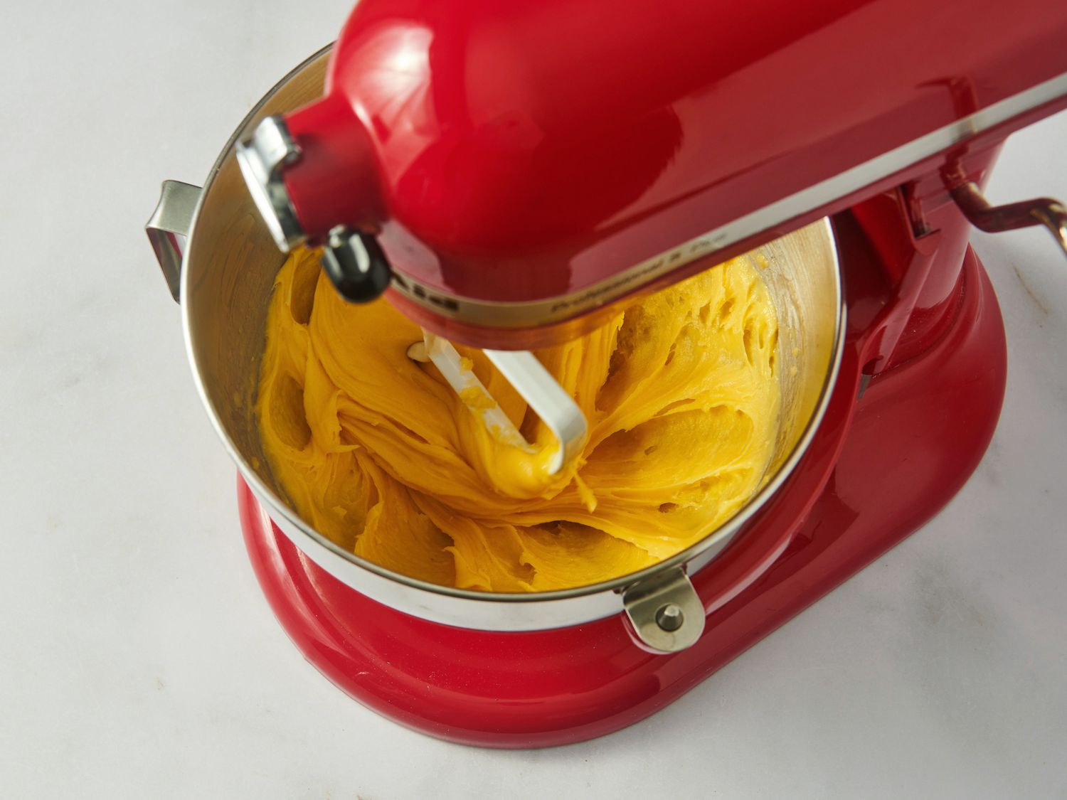 Choux pastry batter in the bowl of a stand mixer.