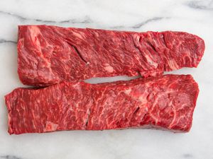 Two pieces of Bohemian cut or bottom sirloin flap meat on marble surface
