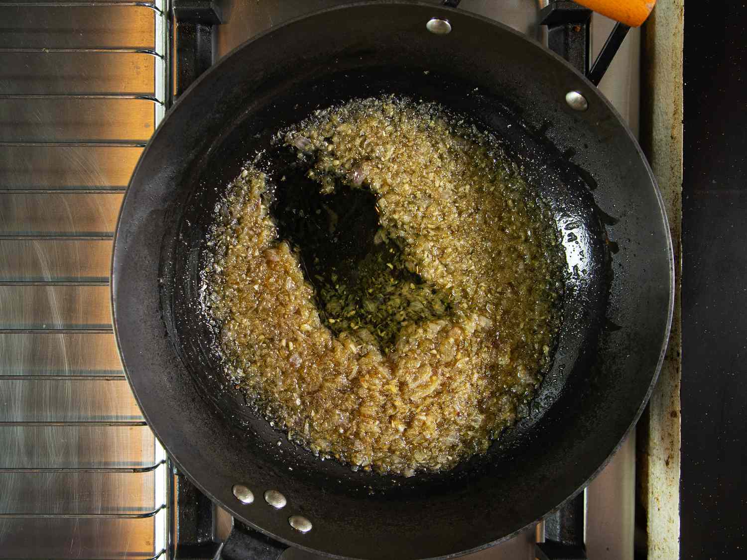 Overhead view of oil separating from onions and garli