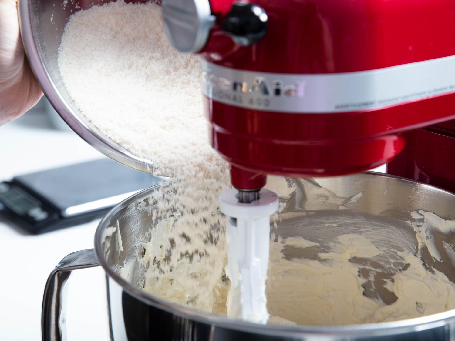 Pouring flour into stand mixer bowl