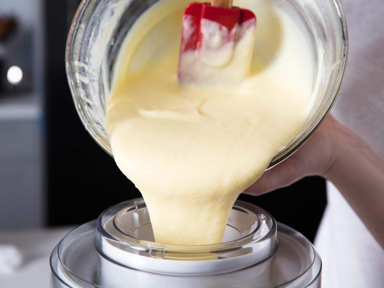 Pouring the fresh pineapple ice cream base into an ice cream machine