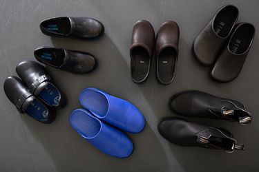 A group of kitchen shoes, including clogs and boots.