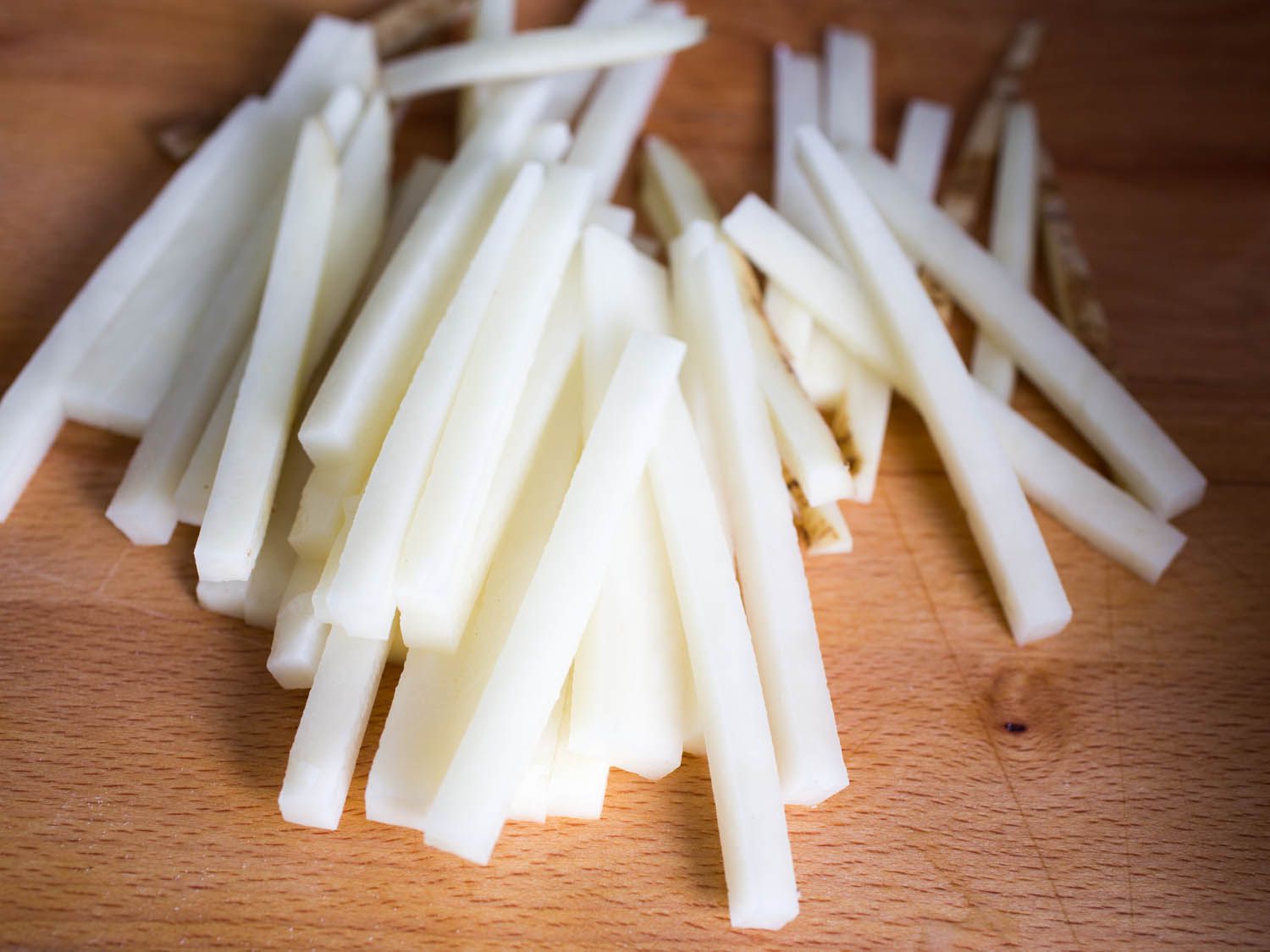 Thin slices of potato on a wood surface