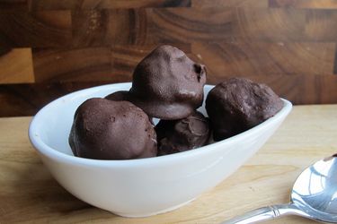 A bowl of chocolate ice cream bon bons, ready to serve.