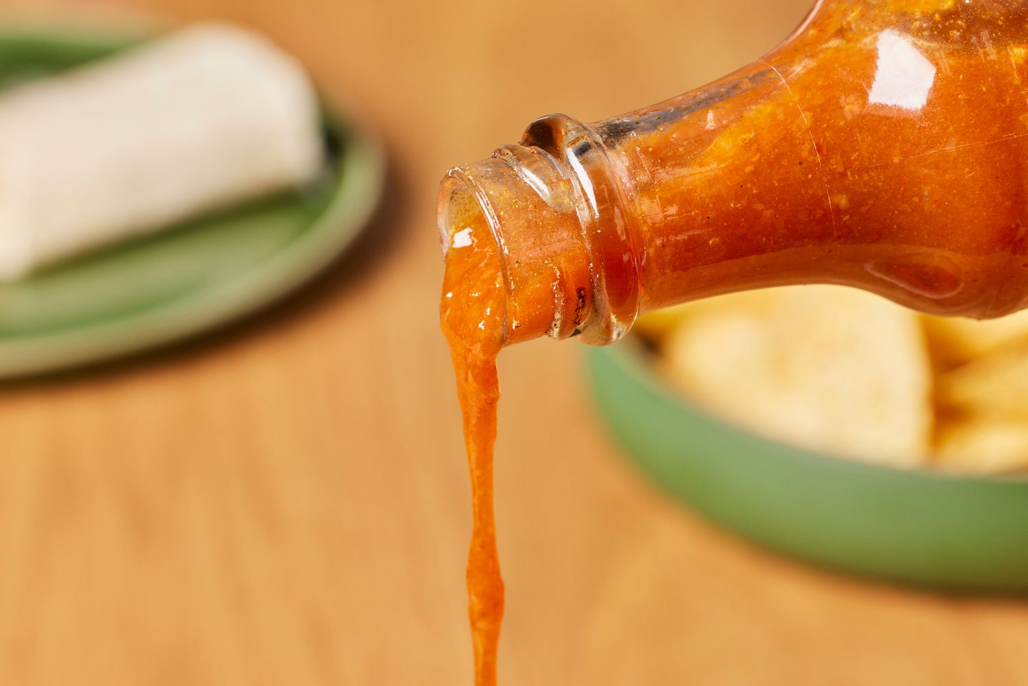 Person pouring Nando's Extra Extra Hot Peri Peri Sauce (4-Pack)