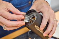 A person assembles the Comandante C40 Nitro Blade Grinder