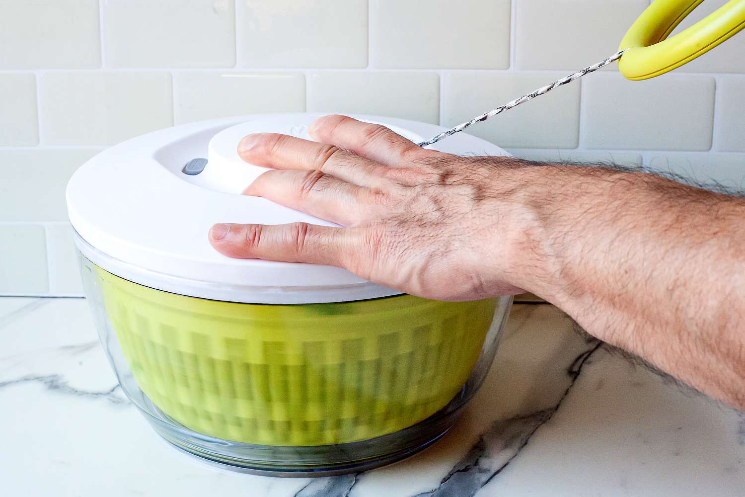 a person pulling the ring on the chef'n spinner