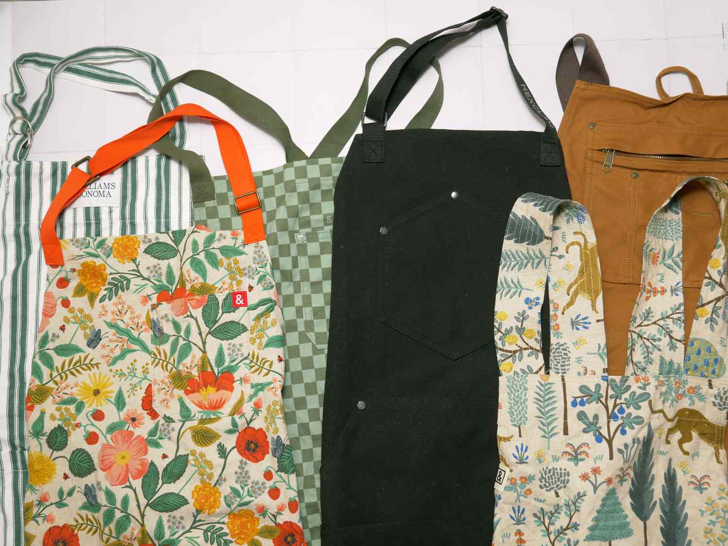 a variety of aprons on a white surface