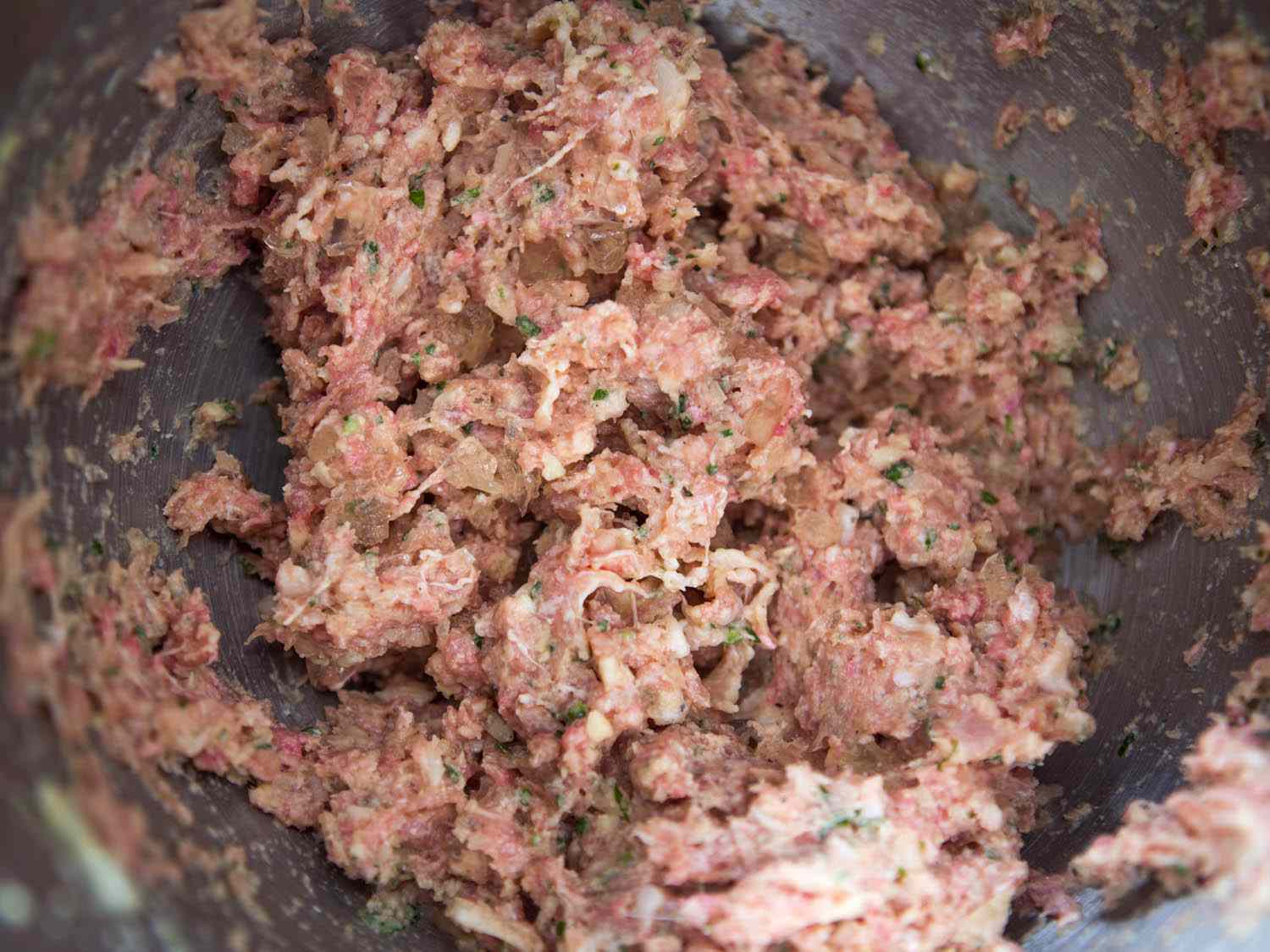 Emulsified meat and panade mixture in stand mixer for meatballs.