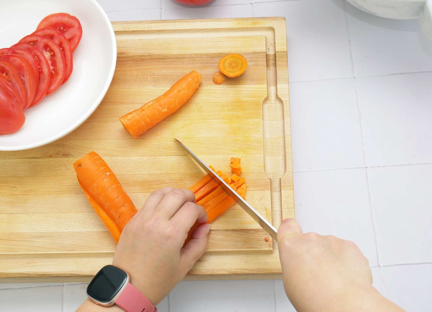 a person dicing carrots