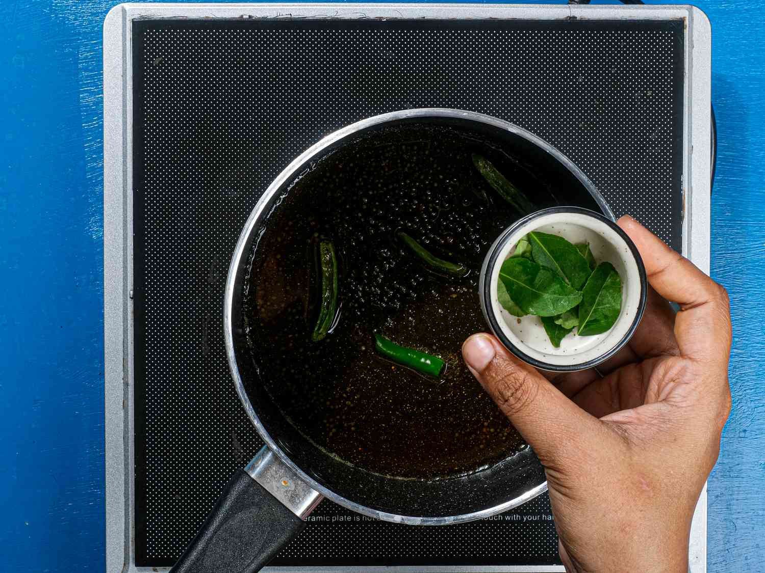 Frersh curry leaves are added.