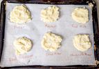 Six portions of mashed potatoes labeled by preparation method on parchment paper