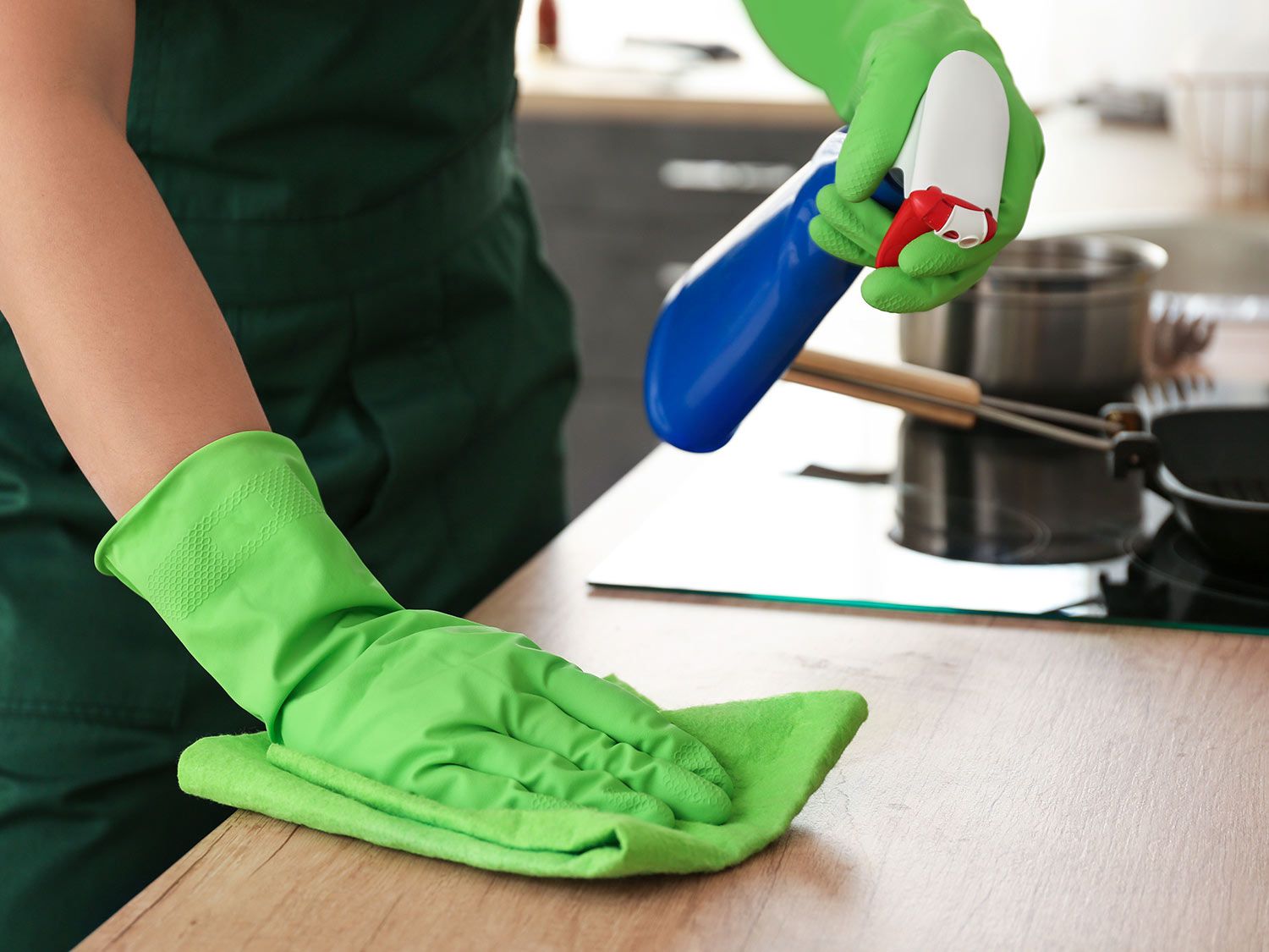 Person cleaning a kitchen counter
