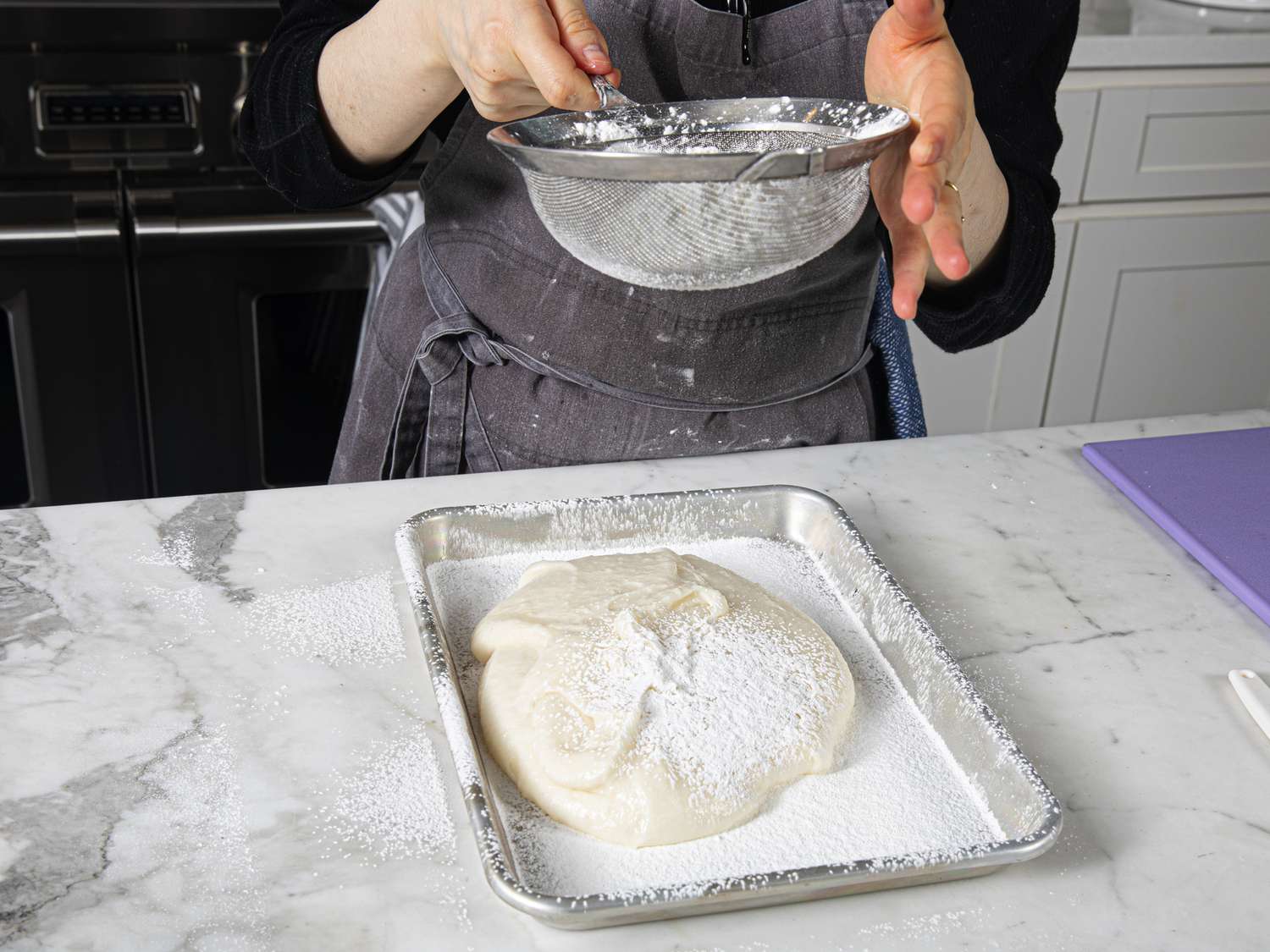 Overhead view of covering mochi with potato starch