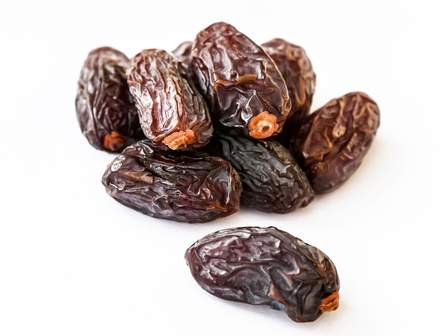 A pile of dried dates commonly used as a sweet snack or ingredient in recipes