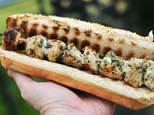 Hand holding a chicken spiedies grilled hoagie