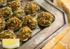 A tray of easy, ultimate Clams Casino with a lemon wedge. 