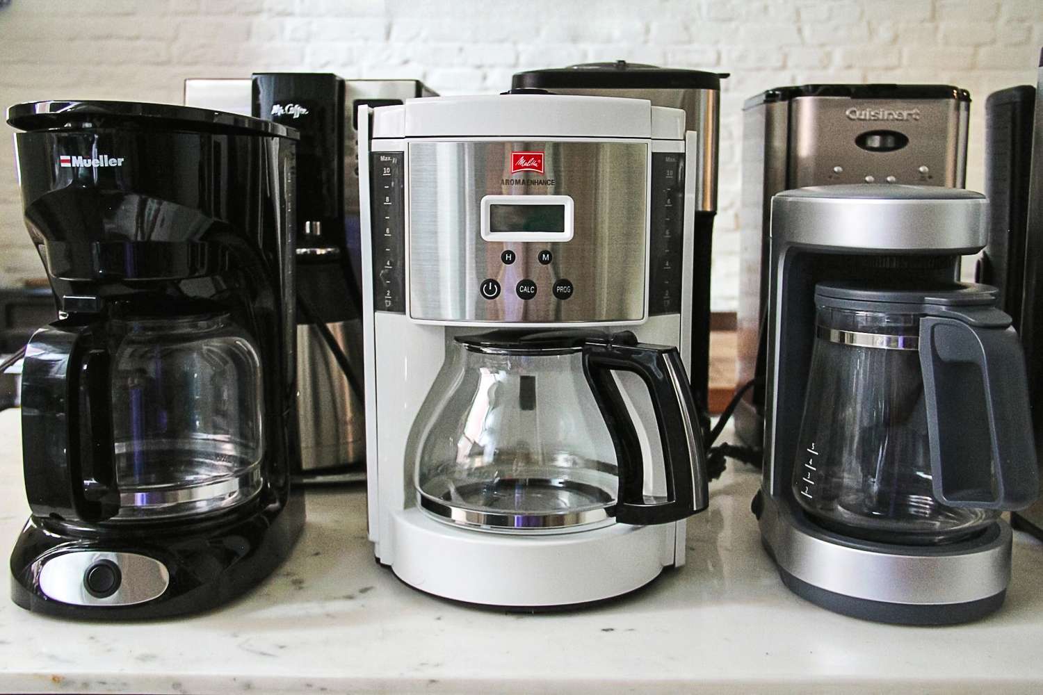 A collection of inexpensive coffee makers on a kitchen counter