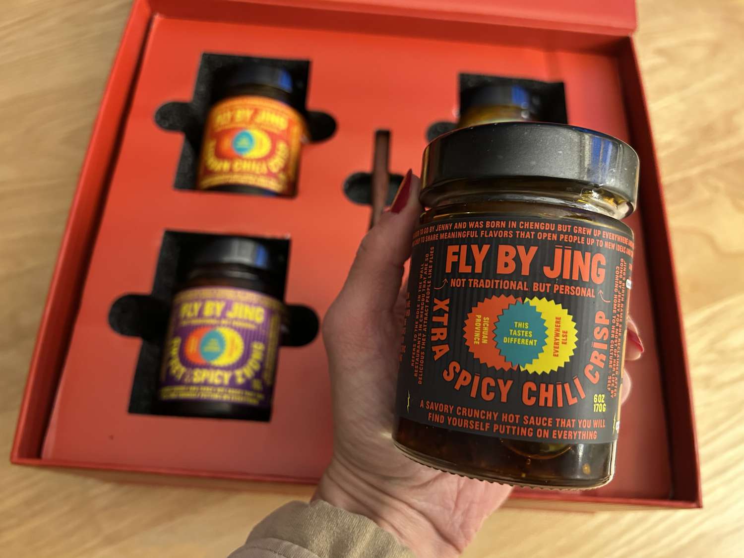 A red box filled with condiments from Fly By Jing