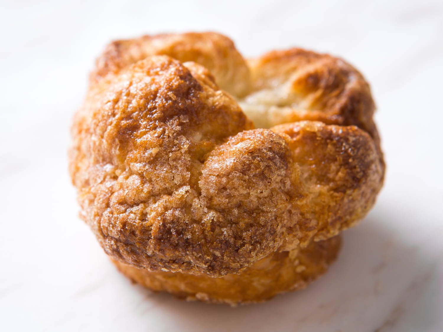 Overhead of kouign amann pastry on white background.