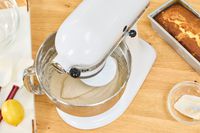 A person makes batter in the KitchenAid Classic Plus Series 4.5 Quart Tilt-Head Stand Mixer