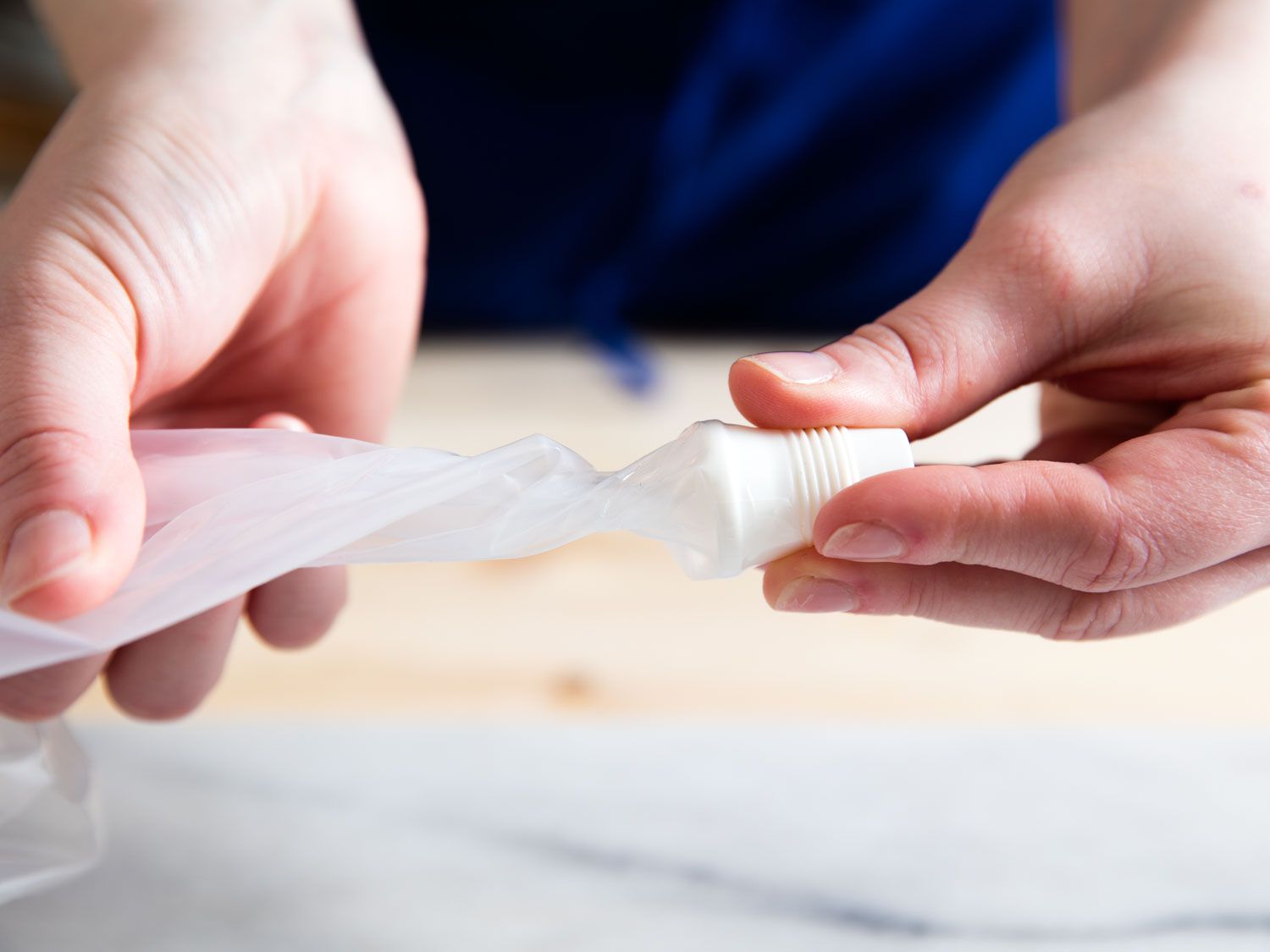 Twisting the tip end of the piping bag keeps the contents from leaking as you fill it.