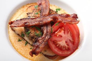 Overhead view of a hot brown burger, served in a shallow white bowl.