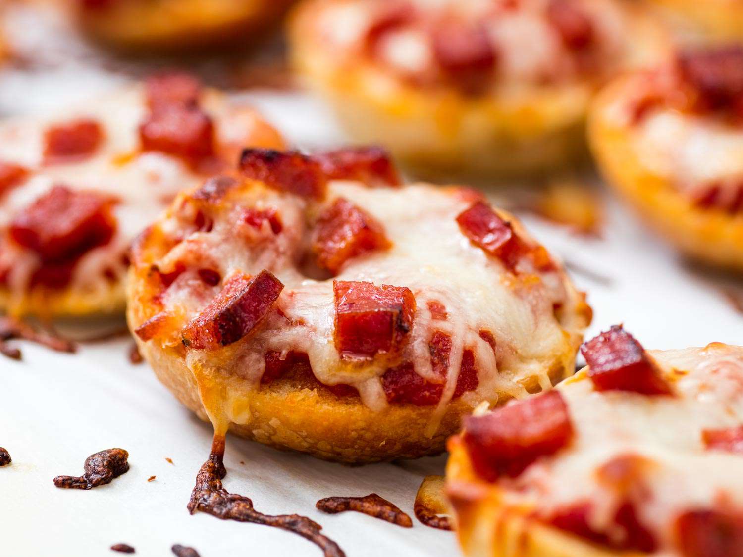 Close-up of a pepperoni-studded bagel bite, ready to serve.
