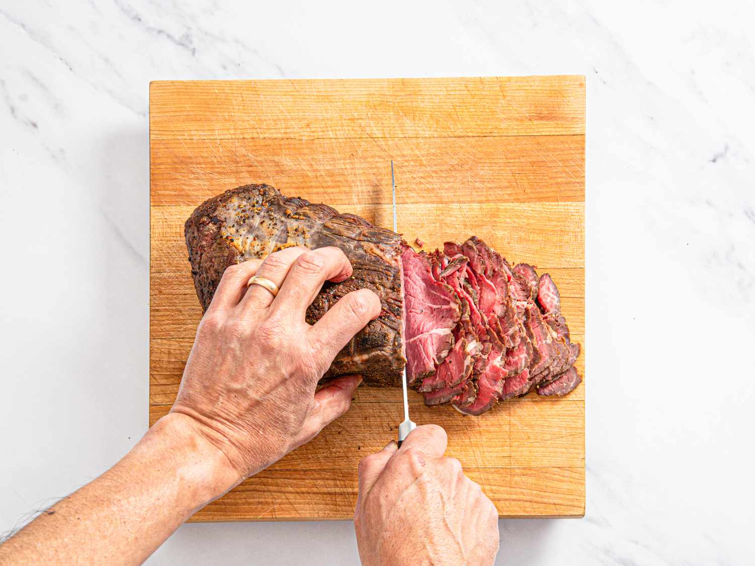 Overhead view of slicing pork roast