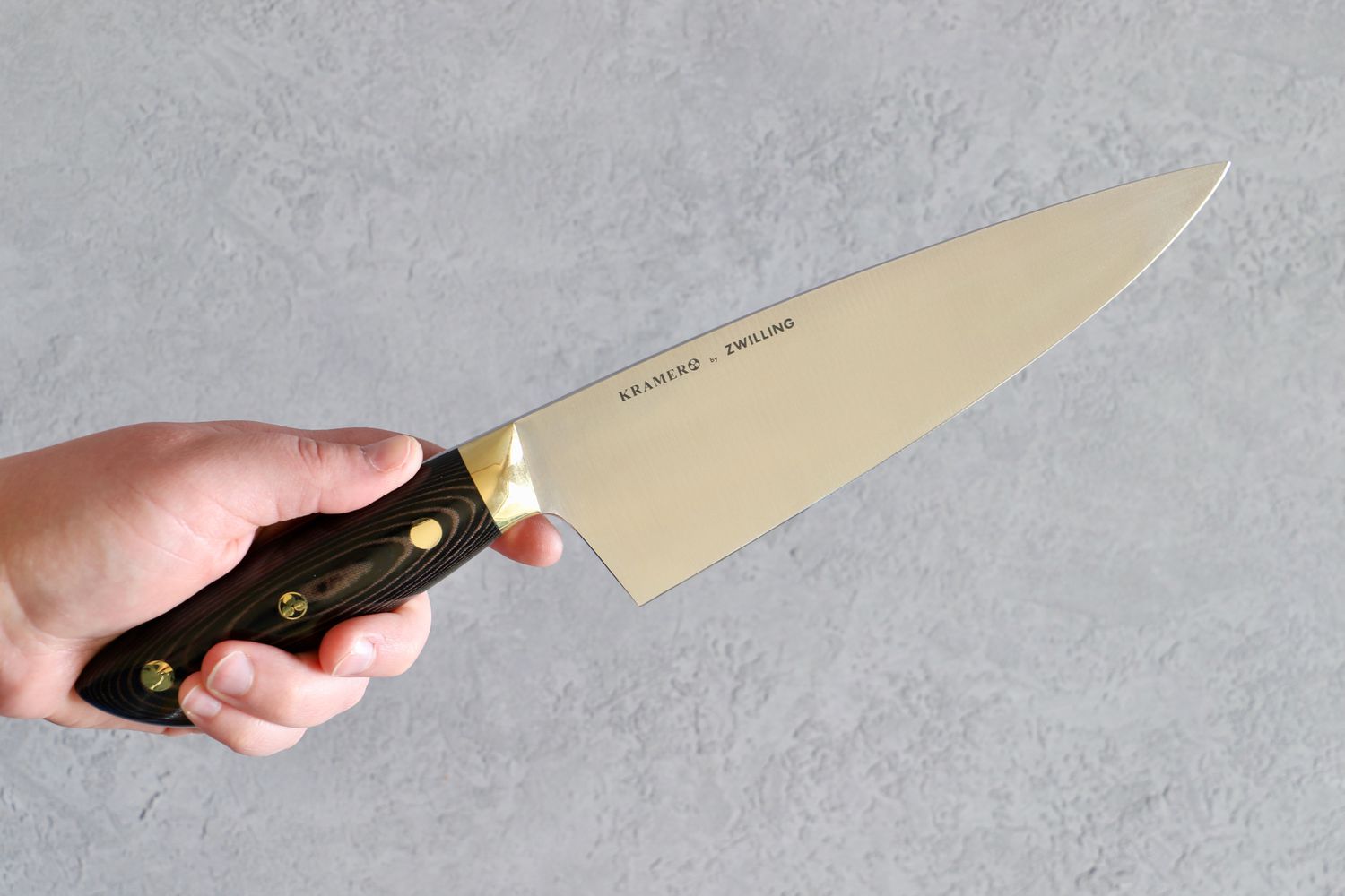 holding the Zwilling Bob Kramer Carbon 2.0 8 inch Chef's Knife