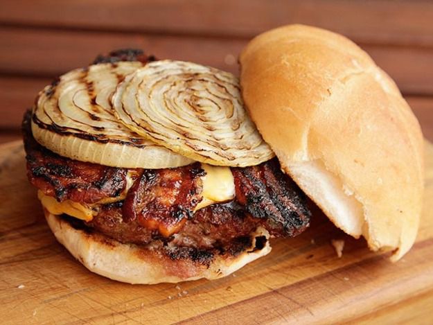 A barbecue bacon burger, topped with two slabs of grilled onion.