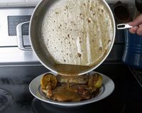 pouring sauce over chicken 