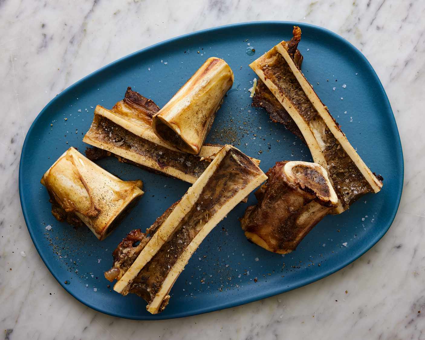 Roasted bone marrow on a blue tray