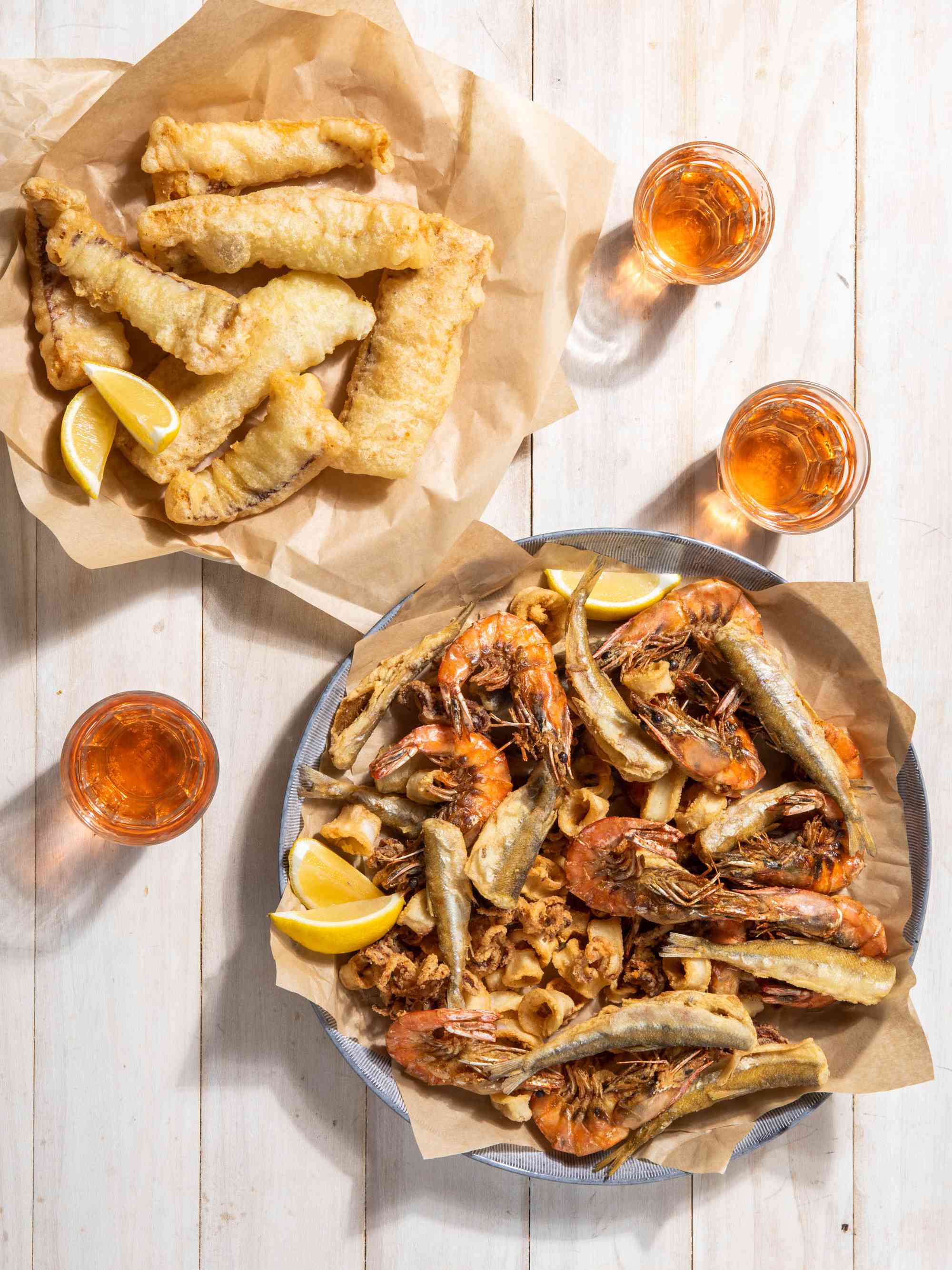 Fritto Misto with alcohol pairings laid out on a white table.