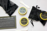 Imperia caviar tins with serving spoons and black pouches