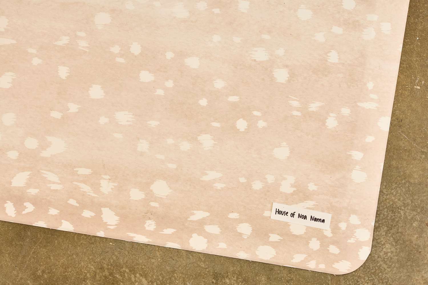 The brand tag on the corner of The House of Noa Nama Standing Mat